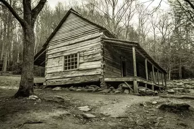 Black and white photo of a creepy cabin in the Smoky Mountains.