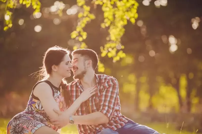 Happy couple relaxing in the woods on their Gatlinburg honeymoon vacation.