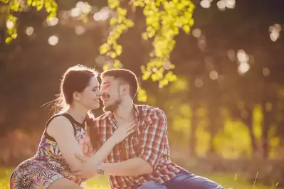 Happy couple relaxing in the woods on their Gatlinburg honeymoon vacation.