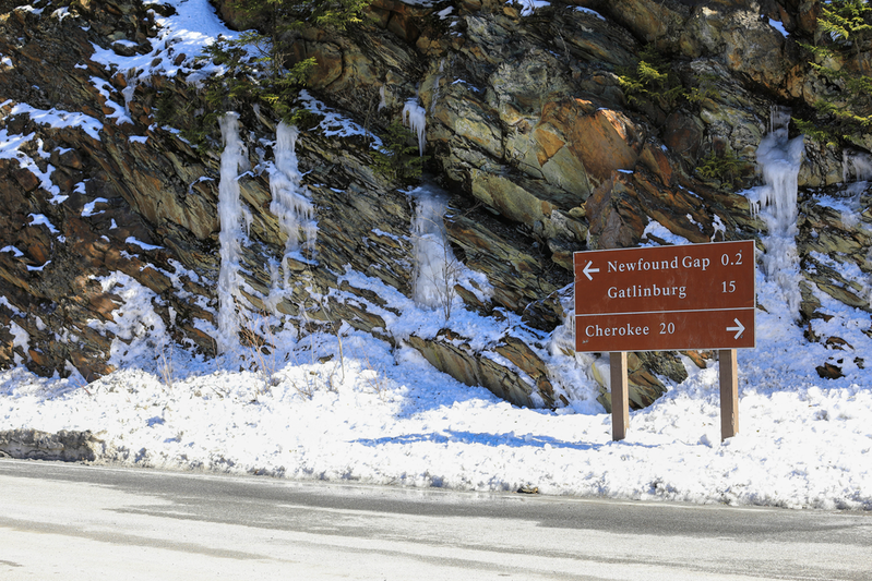 directional sign on Newfound Gap Road surrounded by snow and icicles